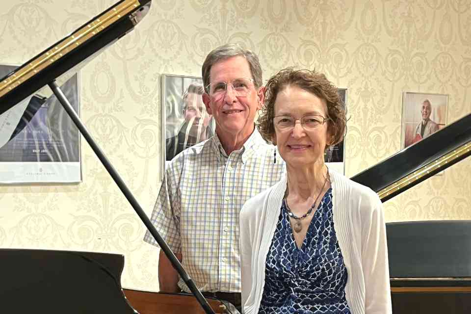 Tom and Kathy Day standing near a piano 